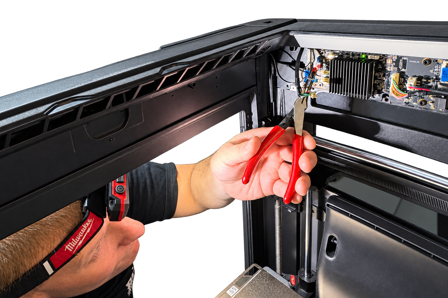 Rocket3D technician repairing the interior of a 3D printer